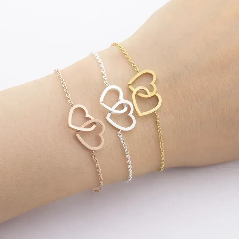 Bracelet en acier inoxydable avec deux cœurs en or rose
